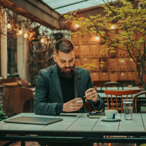 businessman-using-airpods-and-a-laptop-in-a-coffee-shop.jpg